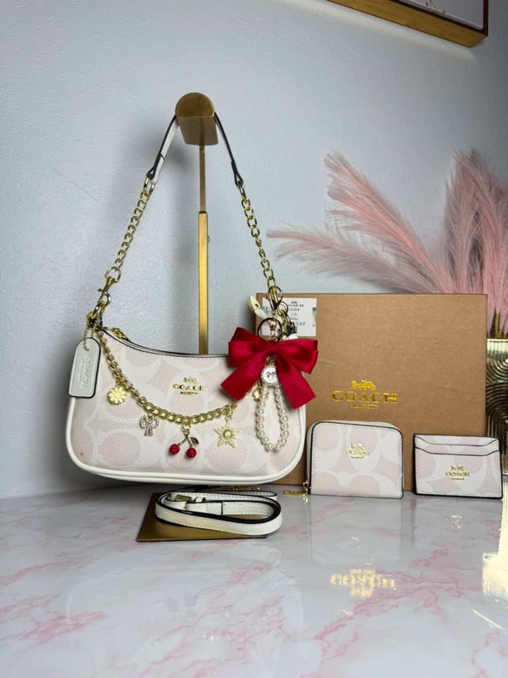 Coach Cream Signature Canvas Shoulder Bag with Red Bow Charm